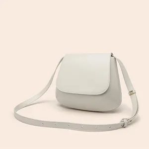 Minimalist PU leather crossbody saddle bag with flap closure and adjustable strap. Perfect daily.