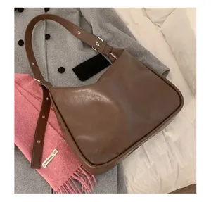 Brown PU leather shoulder bag detail shot, vintage hobo bag with adjustable strap for daily wear.
