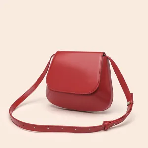 Detailed shot of the red PU leather saddle bag, showcasing fine stitching and smooth flap.