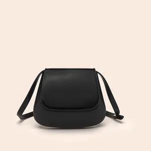 Black PU saddle bag detail, featuring smooth curved design, elegant retro shoulder strap style.