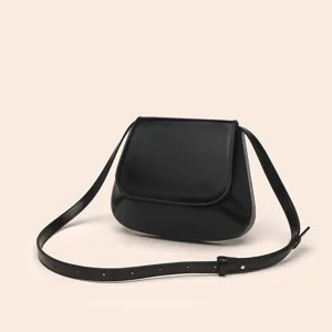 Close-up detail of the vintage black PU leather chestnut saddle crossbody bag with smooth finish.