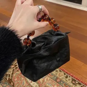 Retro vintage Chinese style beaded handle handbag for women with gathered leather texture.