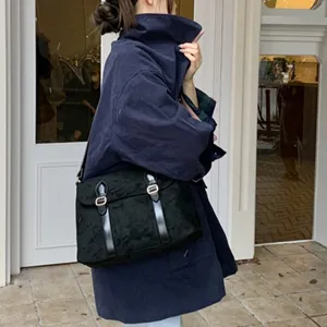 Black suede vintage messenger bag for women, retro shoulder crossbody bag with double buckle.