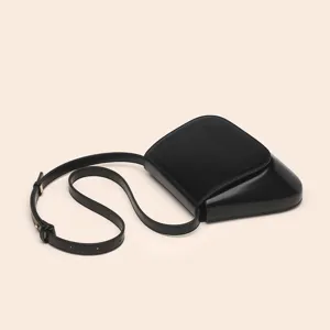 Black PU leather chestnut shoulder crossbody bag detail showcasing unique sleek curved design.