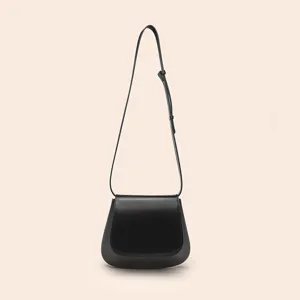 Classic black PU leather saddle bag for women, retro minimalist cross body purse.