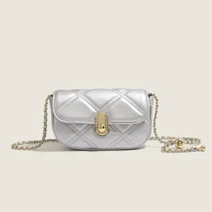 Silver quilted mini shoulder bag for women, elegant luxury small crossbody bag with gold chain.