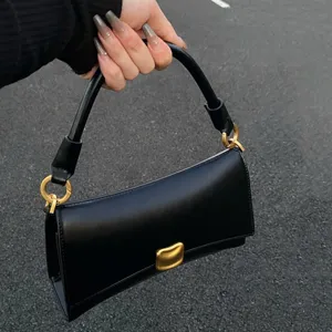 Stylish black underarm baguette bag for women, urban fashion handbag with metal clasp.