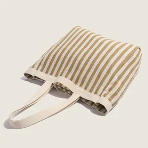 Casual striped canvas tote bag for women, large capacity shoulder handbag for daily commute.