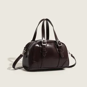 Retro dark brown PU leather pillow handbag for women, stylish vintage shoulder crossbody bag.