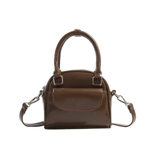 Brown retro shell handbag for women, vintage top handle commute shoulder cross-body bag.