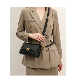Chic black leather shoulder bag for women, stylish baguette handbag with gold tone hardware.