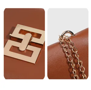 Close-up detail of brown leather women bag featuring gold geometric metal lock and chain.