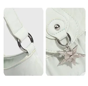 Mint green shoulder bag detail close up, silver hardware metal star pendant design.