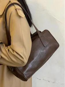 Vintage brown leather shoulder bag for women, casual baguette handbag for daily commuting.