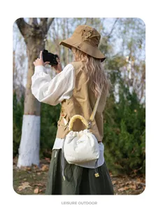 Canvas padded mirrorless camera bag, drawstring bucket bag with yellow handle and strap.