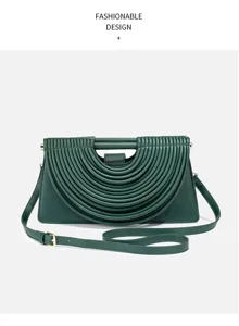Close-up of the dark green pleated handbag, highlighting its arch design and metal hardware.