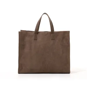 Brown suede tote bag detail showcasing premium soft texture and minimalist structured design.