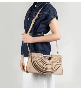 Detailed view of the stylish beige pleated crossbody shoulder bag featuring a unique arched design.