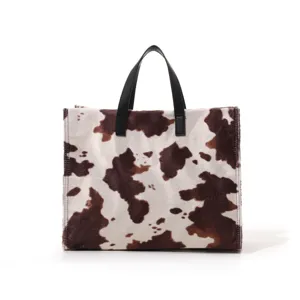 Chic cow print plush tote bag for women, large capacity fluffy handbag, autumn winter fashion accessory.