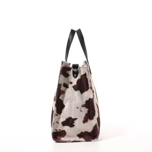 Close-up detail showcasing the soft fluffy animal print texture and black leather handle.