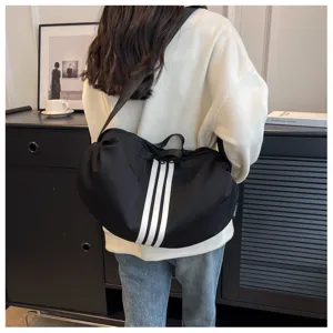 Black large capacity canvas shoulder bag with classic white stripes, casual travel crossbody style.