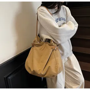 Casual nylon shoulder bag for women, lightweight minimalist tote bag with adjustable side buckles.