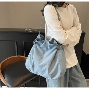 Light blue nylon shoulder bag for women, simple casual daily tote handbag commute style.