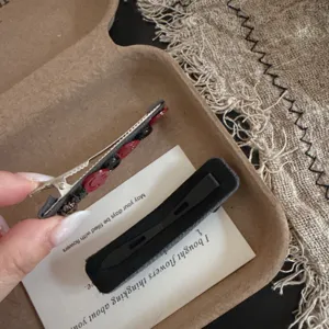 Detailopname van vintage haarspelden met schattig rood gezicht en zwarte barrette.