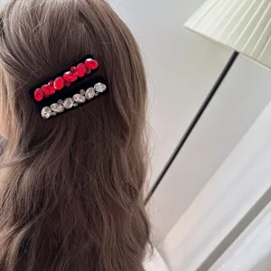 Détail en gros plan de la pince à cheveux rétro en velours strass, élégante épingle.