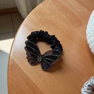Black mesh butterfly rhinestone hair scrunchie detail view, elegant ponytail tie.