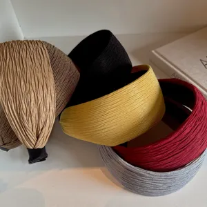 Detailed shot of wide fabric headbands in assorted colors, retro style hair accessory.