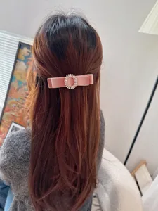 Pink velvet hair clip with sparkling rhinestone oval bow design for women retro style.
