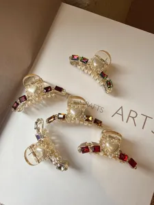 Crystal pearl hair claw clips detail, sparkling rhinestone hair catch for elegant half-up hairstyles.