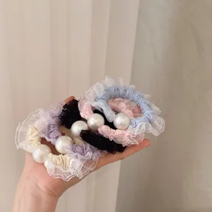 Lace scrunchie detail view, elegant pearl hair tie, elastic ponytail holder for women.