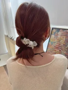 Detail shot of a Korean-style mesh polka dot hair scrunchie with pearls for women.