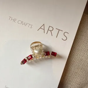 Detailed close-up view of the sparkling red crystal heart pearl hair claw clip design.