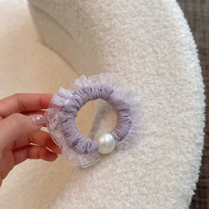 Elegant purple hair scrunchie with white lace mesh ruffles and pearl detail for women styling.