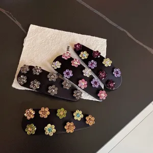 Close-up detail of vintage satin rhinestone floral hair clips, side clips for daily hair styling.