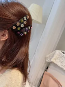Exquisite satin rhinestone flower hair clip detail shot, elegant vintage fabric side clip.