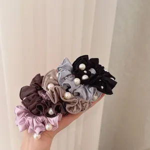 Detailed close-up view of Korean satin pearl scrunchies in multiple colors, elegant hair ties.