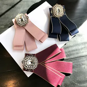 Exquisite vintage court style fabric bow brooch set featuring sparkling crystal and pearl details.