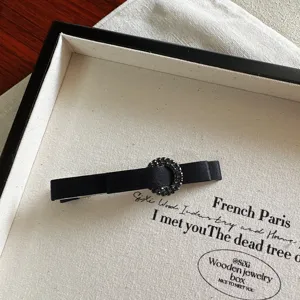 Elegant black fabric hair clip with sparkling rhinestone ring buckle for women and girls.