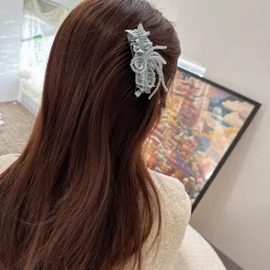 Detail view of a chic grey crystal floral hair insert comb, showcasing elegant side styling.
