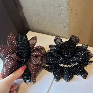 Detailed view of French vintage polka dot mesh hair claw, elegant hair accessory for women.
