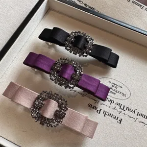 Korean fabric bow hair clip with sparkling rhinestones, elegant spring clip for women.