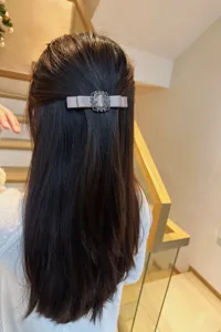 Elegant fabric bow hair clip with sparkling crystal square buckle for stylish hairstyles.