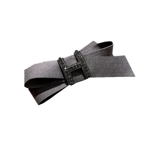 Elegant fabric bow hair clip with sparkling rhinestone H-buckle detail for women and girls.