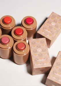Close-up of pocket cream blush stick and packaging box, multi-color creamy texture.