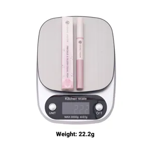 Detail view of Young Vision dual-ended blush pen placed on a digital scale showing weight.