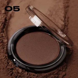 Close-up detail shot of a brown contour powder compact with a clear flip lid on dark powder background.